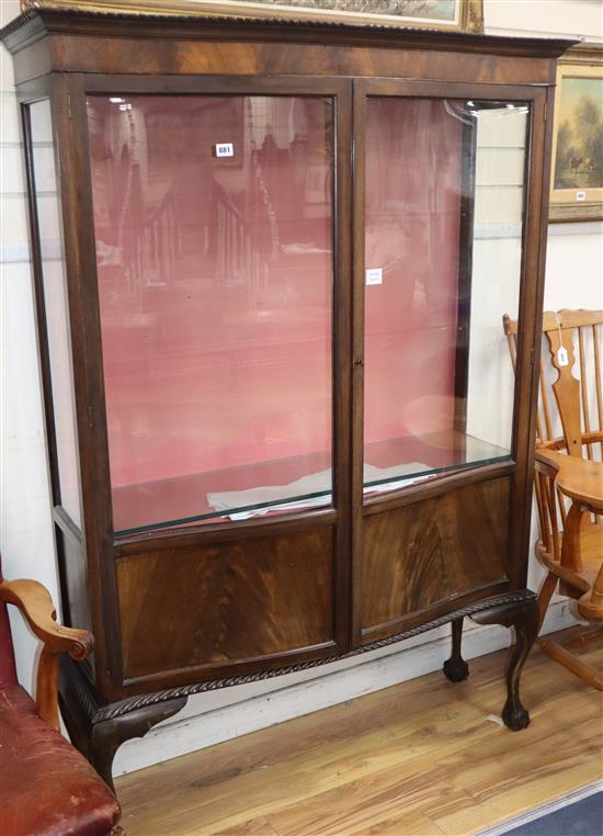 An early 20th century mahogany serpentine fronted display cabinet W.122cm